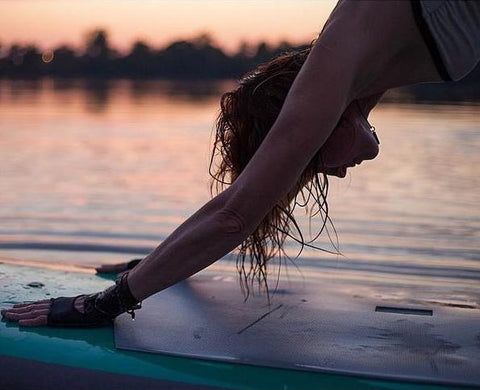 Yogi in Down Dog on a Stand Up Paddle Board