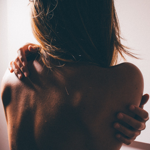 Girl holding back, relief from back pain